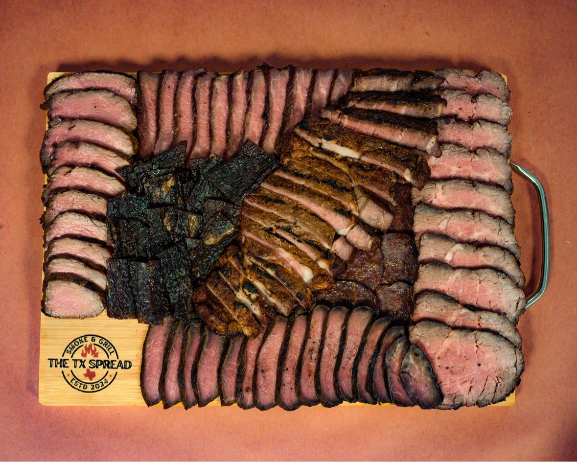 The Texas board — a generous Tx Spread board of sliced smoked meats arranged in rows