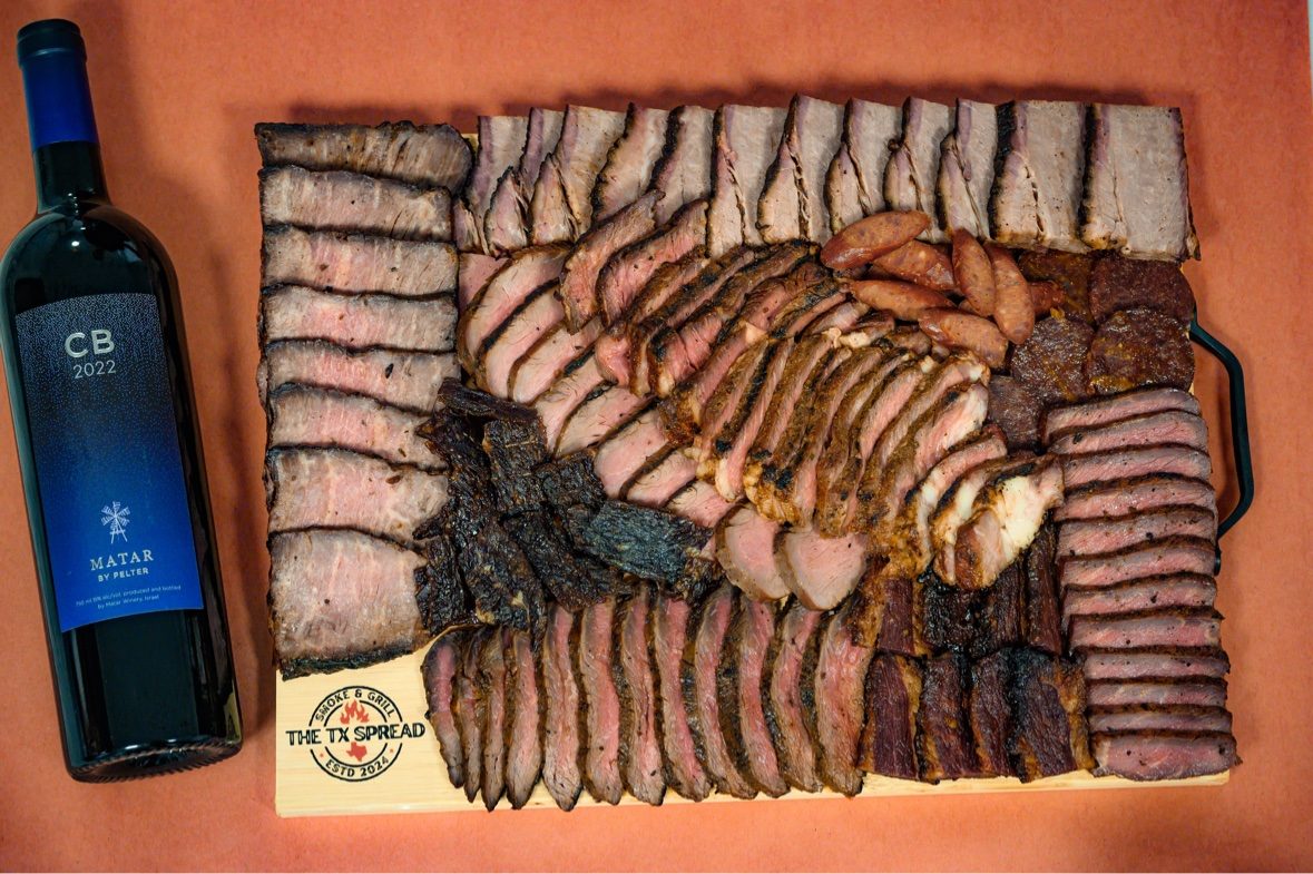 Tx Spread board photographed from above alongside a bottle of red wine