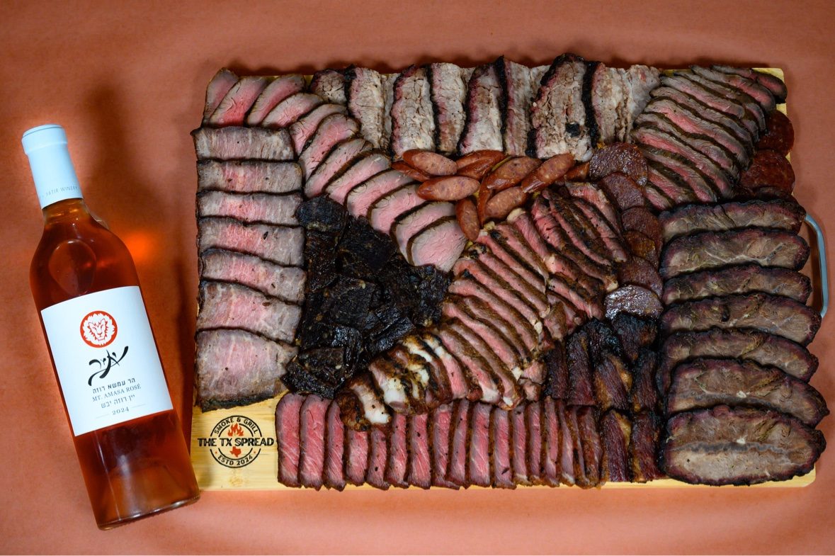 Tx Spread board photographed from above alongside a bottle of rosé wine