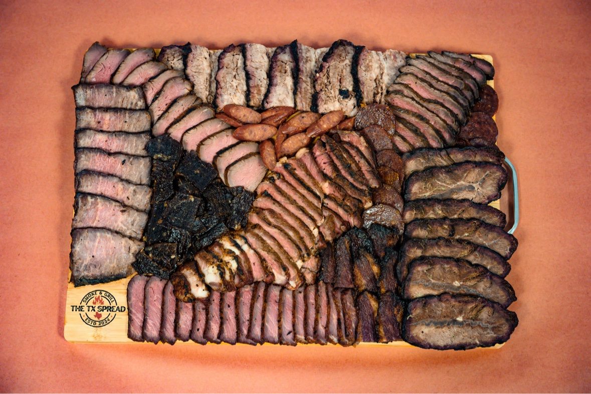 The Signature board — a Tx Spread board of sliced smoked meats with a seared steak centerpiece