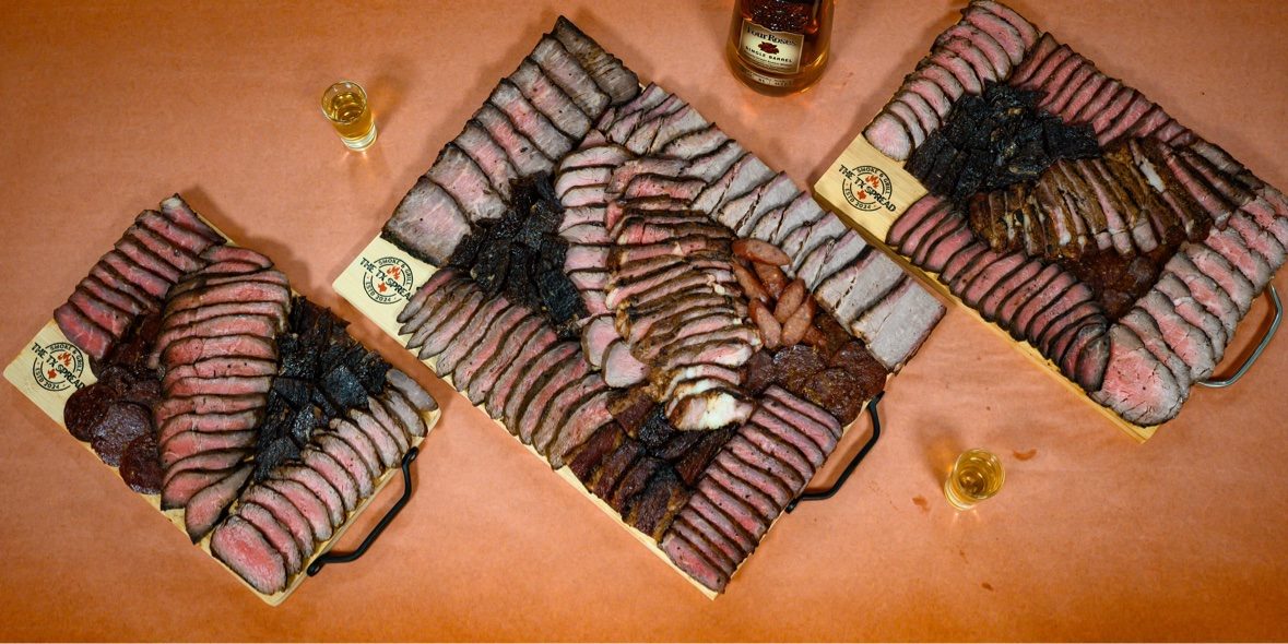Three Tx Spread boards arranged on a table for a gathering
